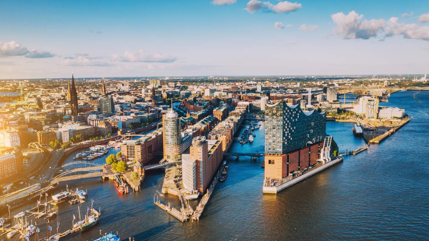 Luftaufnahme der Hamburger Hafenstadt ueber dem blauen Hafen  | © Gettyimages.com/Nikada
