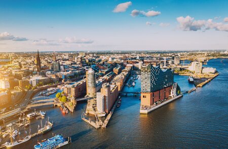 Luftaufnahme der Hamburger Hafenstadt ueber dem blauen Hafen  | © Gettyimages.com/Nikada
