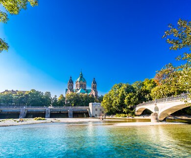 Sommerlandschaft von München, der Fluss Isar und die Lukaskirche im Hintergrund | © Gettyimages.com/StreetFlash