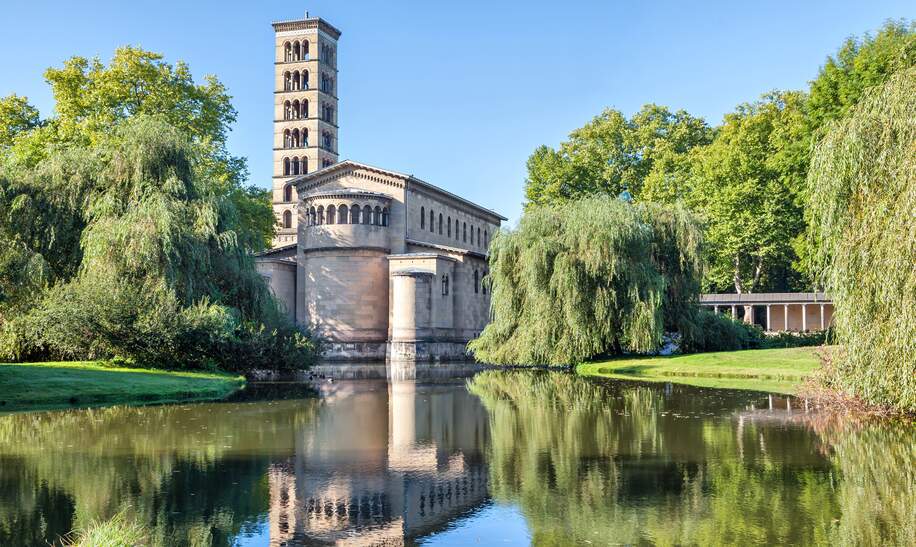 Blick vom Wasser auf die Friedenskirche in Postdam im Schlosspark von Sanssouci | © Gettyimages.com/bbsferrari