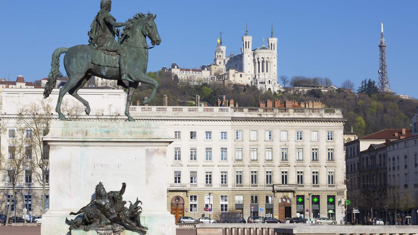 Blick auf das Reiterstandbild Ludwigs XIV. am Place Bellecour mit Basilika im Hintergrund | © Gettyimages.com/vwalakte
