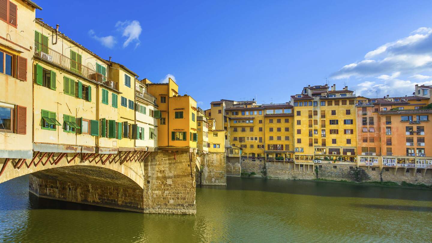 Ponte Vecchio bei strahlendem Sonnenschein mit der alten Brücke, dem mittelalterlichen Wahrzeichen am Fluss Arno | © Gettyimages.com/StevanZZ 