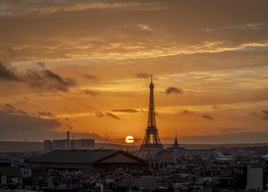 Sonnenuntergang über den Dächern von Paris mit dem Eiffelturm im Hintergrund | © Gettyimages.com/FranckLegros