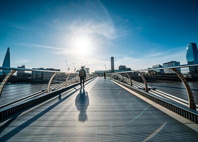 Menschen gehen auf die Millenium Bridge, London | © Gettyimages.com/CHUNYIP WONG