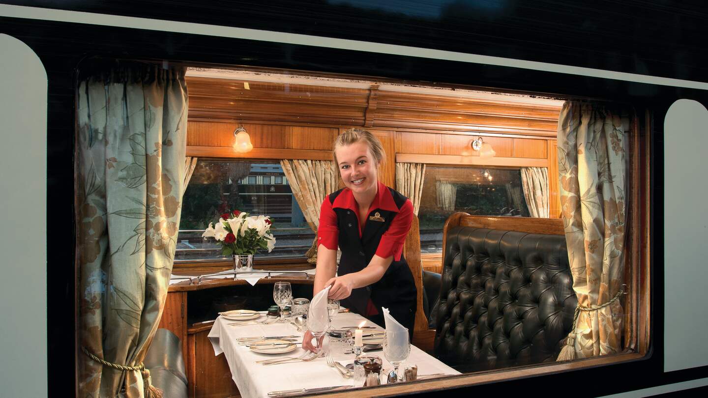 eine freundliche Servicekraft in einem eleganten Speisewagen der Rovos Rail | © DOOKPHOTO
