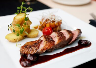 Gebratene Ente mit Birne, mariniert in Rotwein und Mascarpone Rose | © Gettyimages.com/mtoome