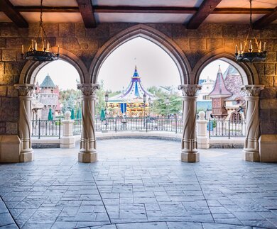 Attraktion Carrousel Lancelot in Disneyland Park, Bereich Fantasyland, aufgenommen von den Torboegen des Schlosses | © Disney
