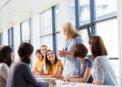 ruppe von Frauen, die an einer Schulung teilnehmen, zusammenarbeiten und diskutieren | © Gettyimages.com/izusek 