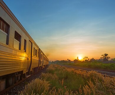 Zug bei Sonnenaufgang | © Gettyimage/Thampapon